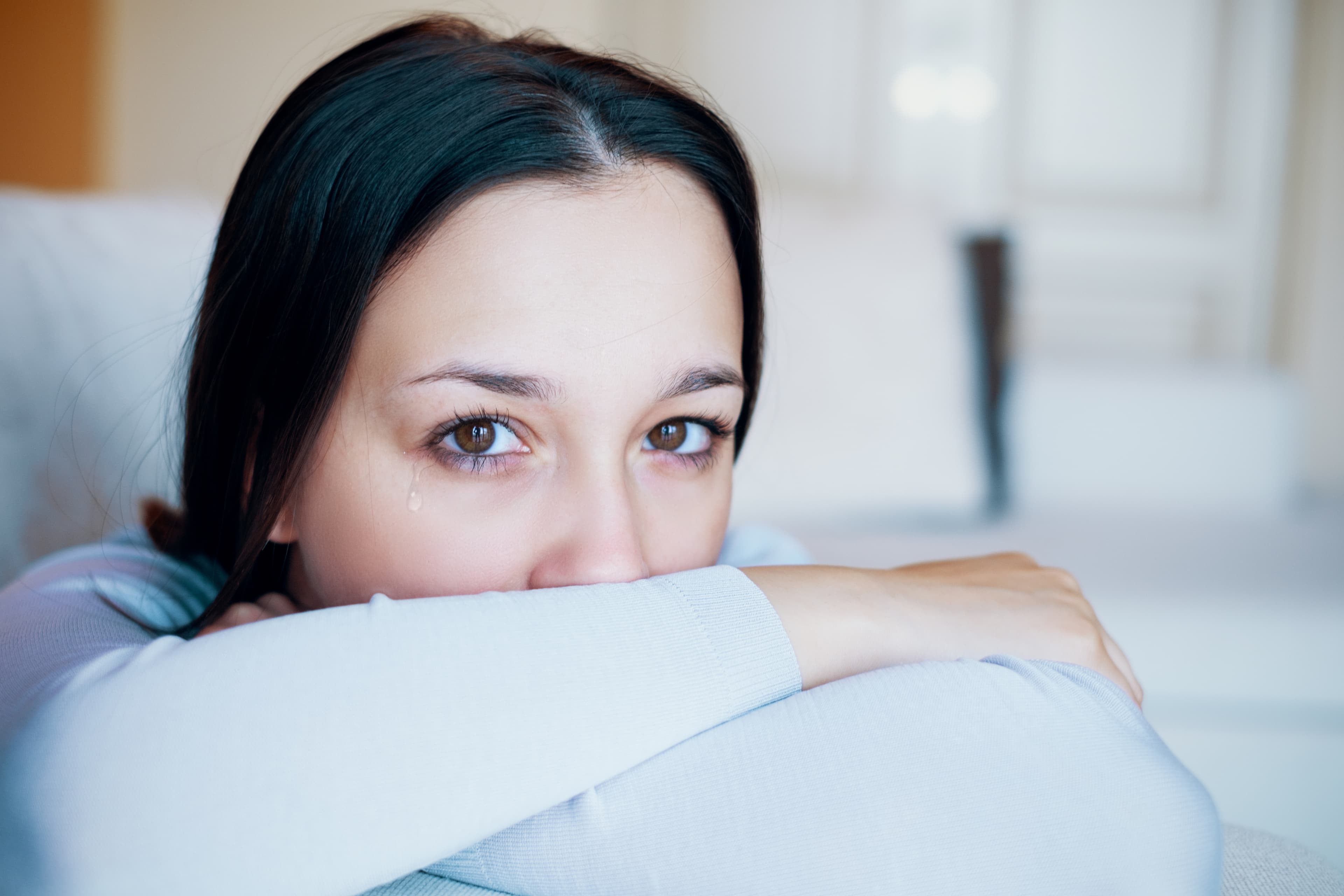 Sad young woman feeling lonely crying about relationship problems