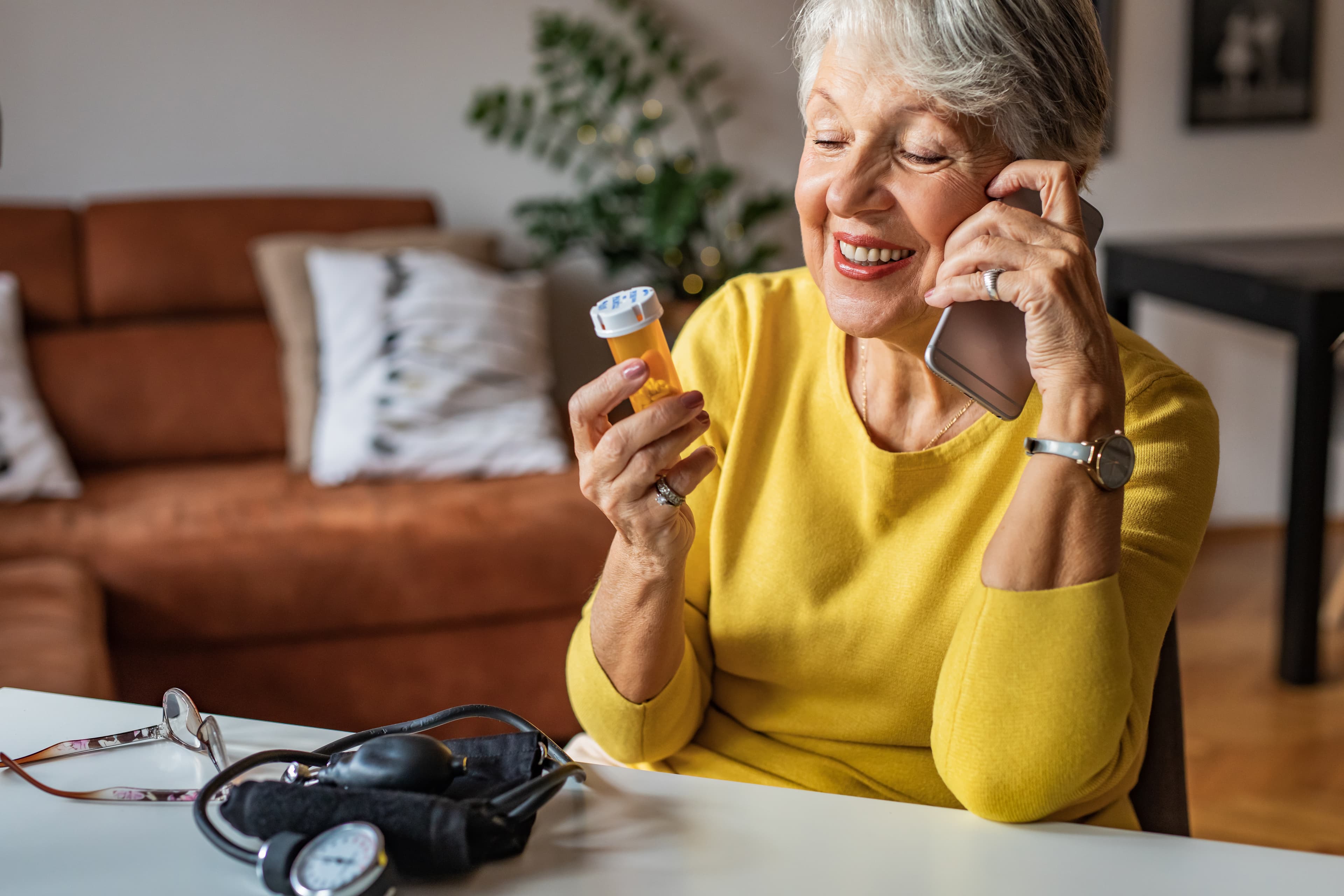 Senior woman on phone pill bottle