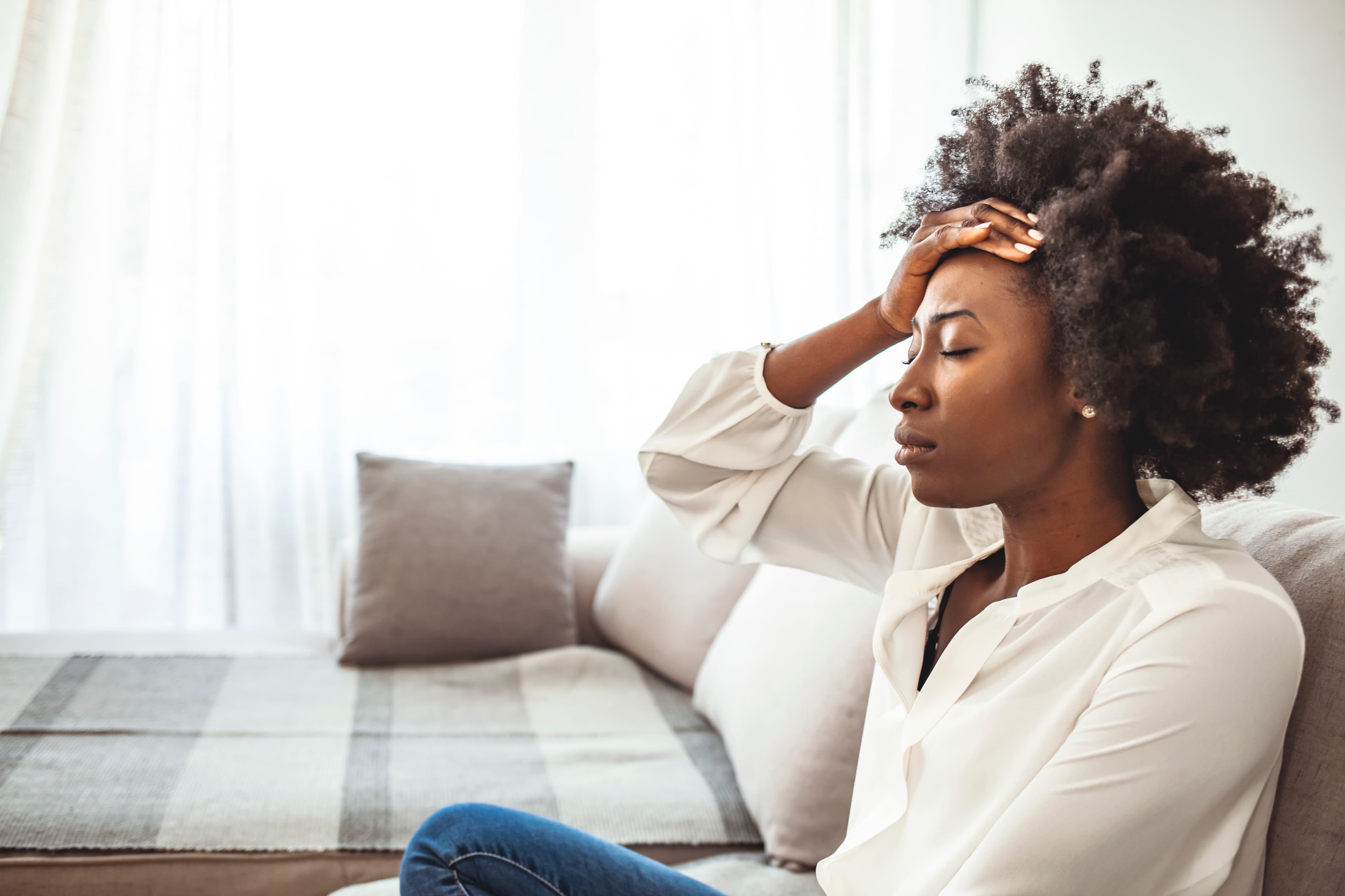 Woman holding head stressed