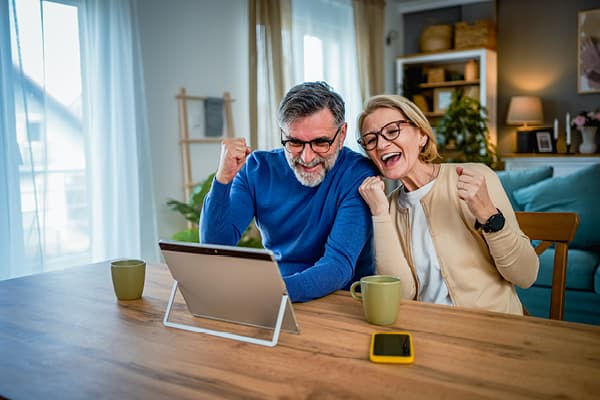 Couple at table cheering