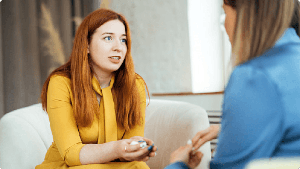 red hair lady talking on couch