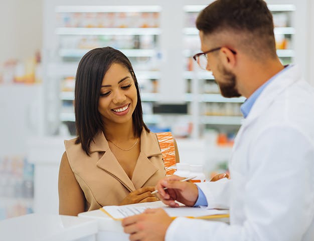 Dark-haired female. Cheerful girl expressing positivity while looking at prescription
