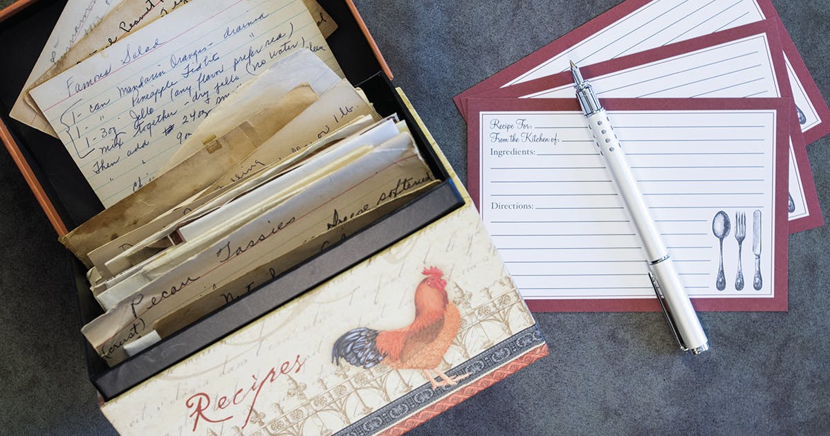 An open recipe box displays handwritten recipe cards.