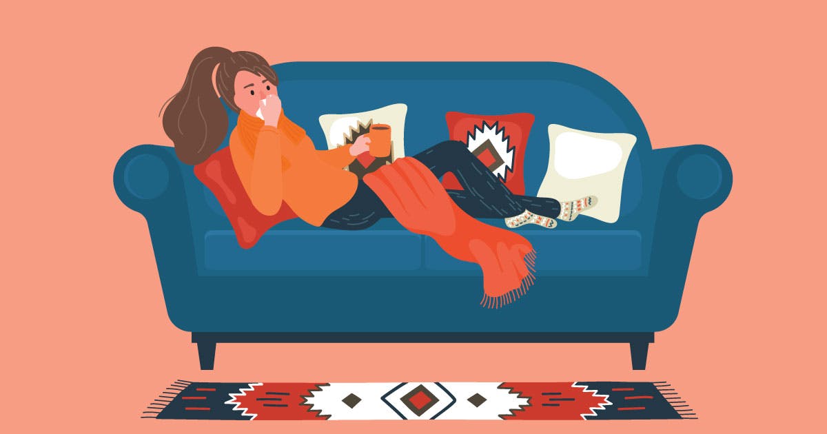An illustration of a young woman on a couch blowing her nose and holding a hot drink.