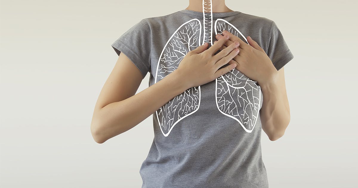 A drawing of lungs superimposed on the torso of someone wearing a gray T-shirt.
