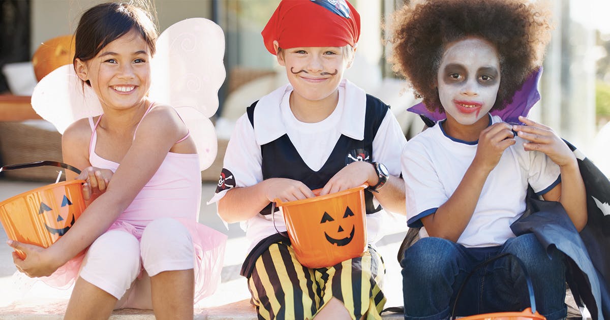 Three children dressed up for Halloween.