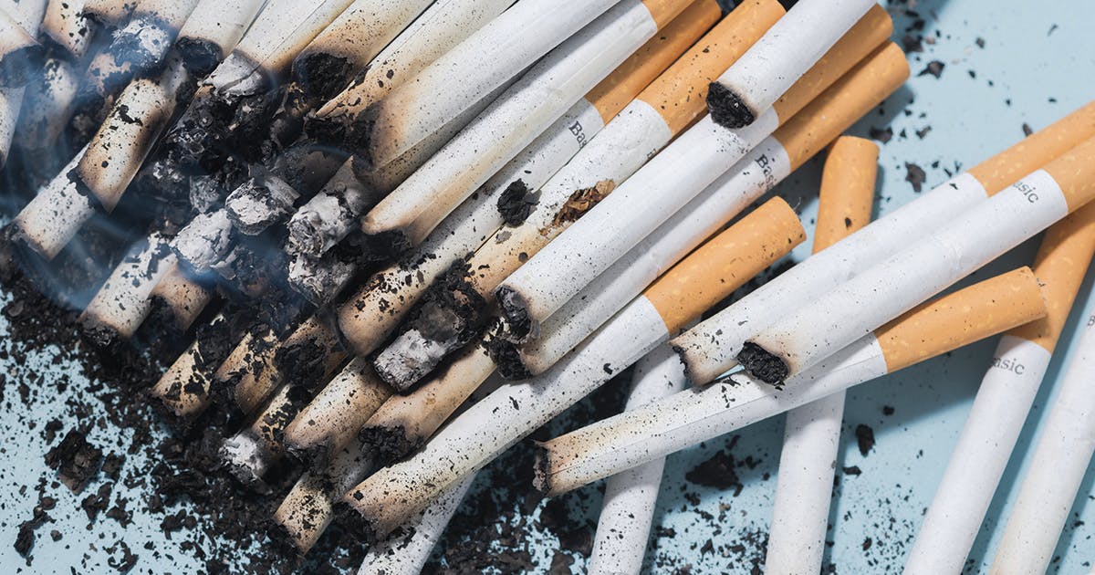 A pile of partially burned cigarettes and ash. 