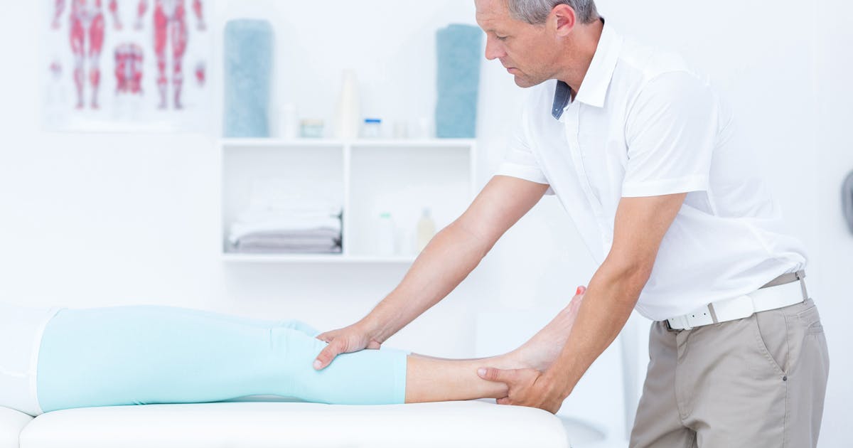 A man massages a patient's leg