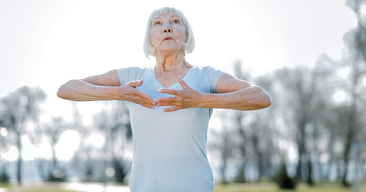 Older woman exercising in an outdoor setting.