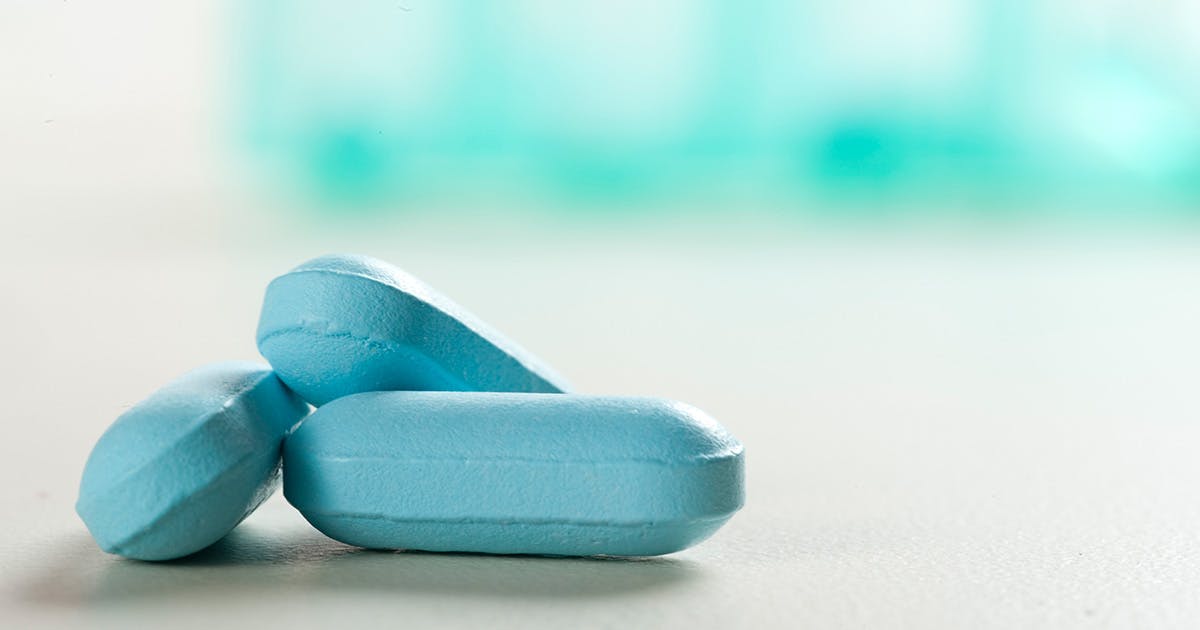 Three blue tablets sitting on a counter.