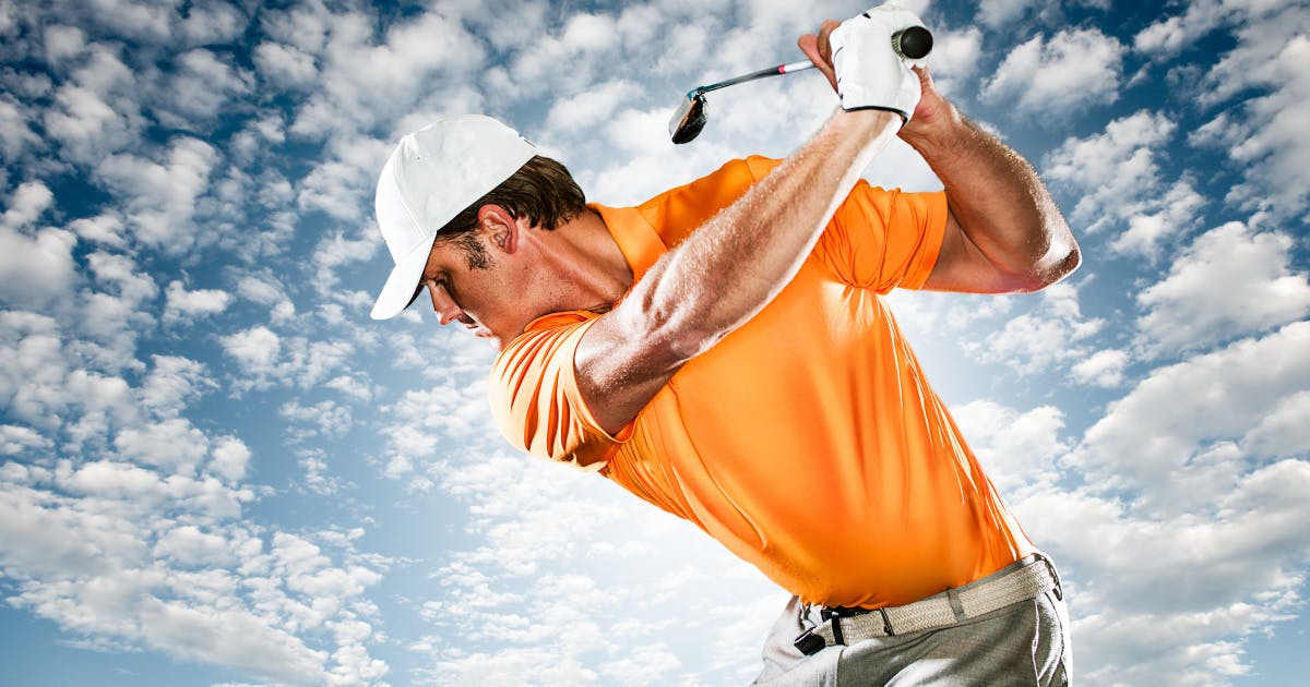 Dramatic image of a man golfing