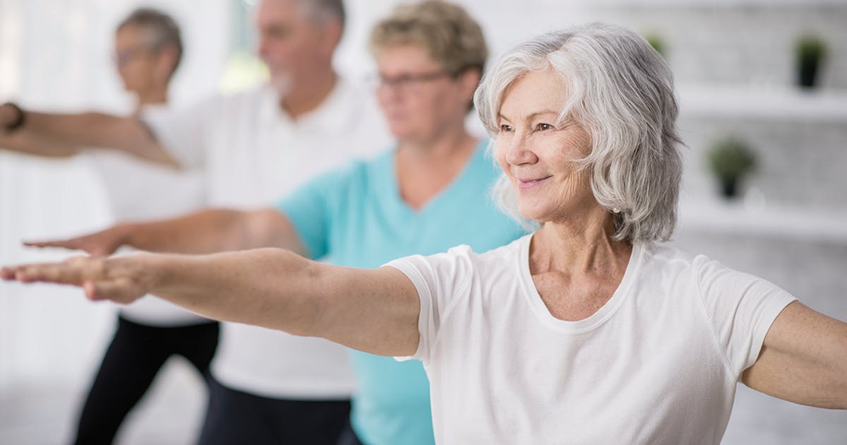 A group of aging adults participating in a tai chi class.