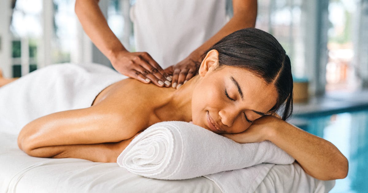 Woman laying on her stomach while receiving a massage.