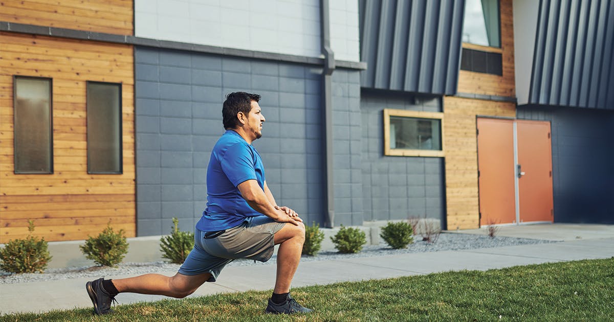 A man stretching outside before exercising.