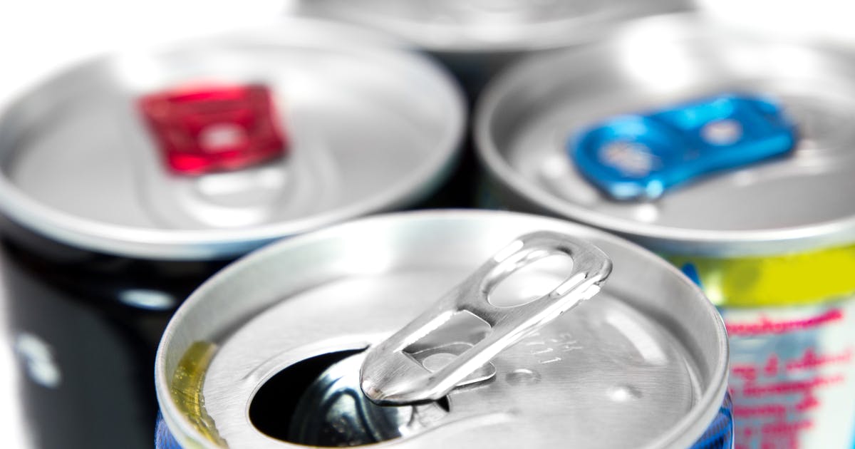 Close-up of the tops of four energy drink cans