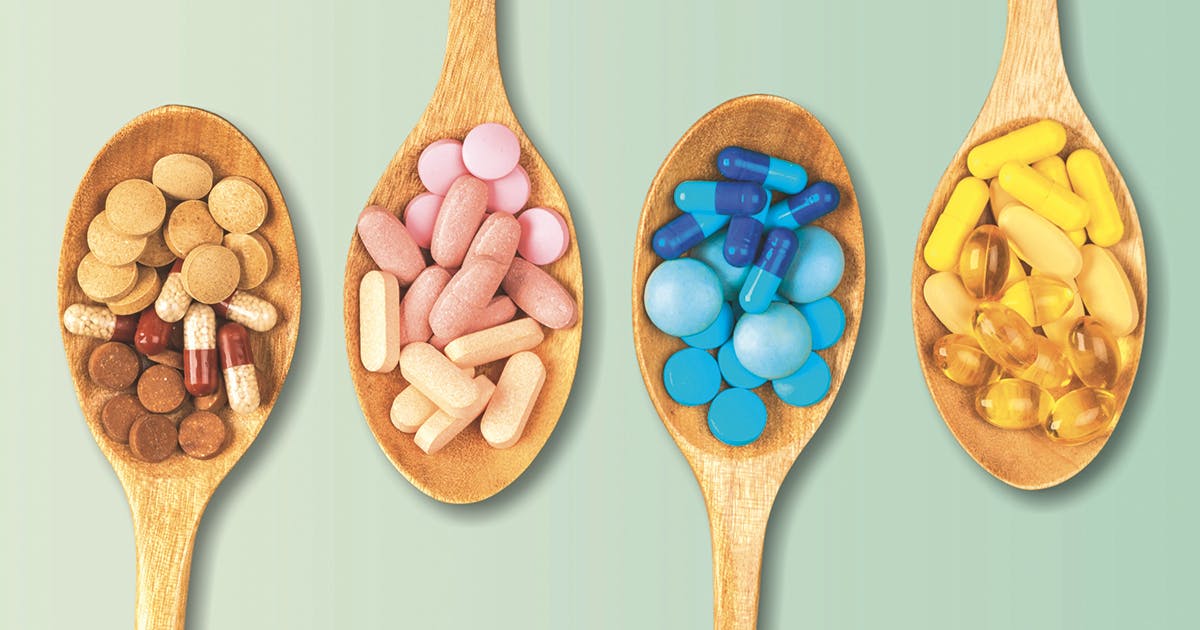 A variety of pills in wooden spoons. 