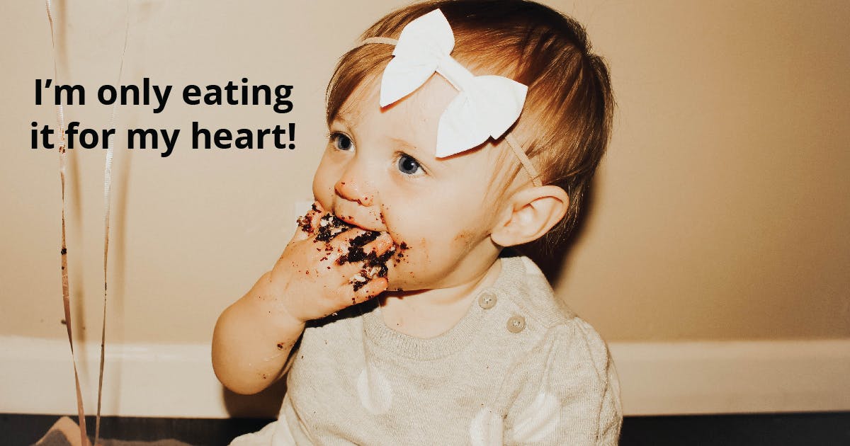 Toddler with chocolate on her face and hand. Text reads: I'm only eating it for my heart!