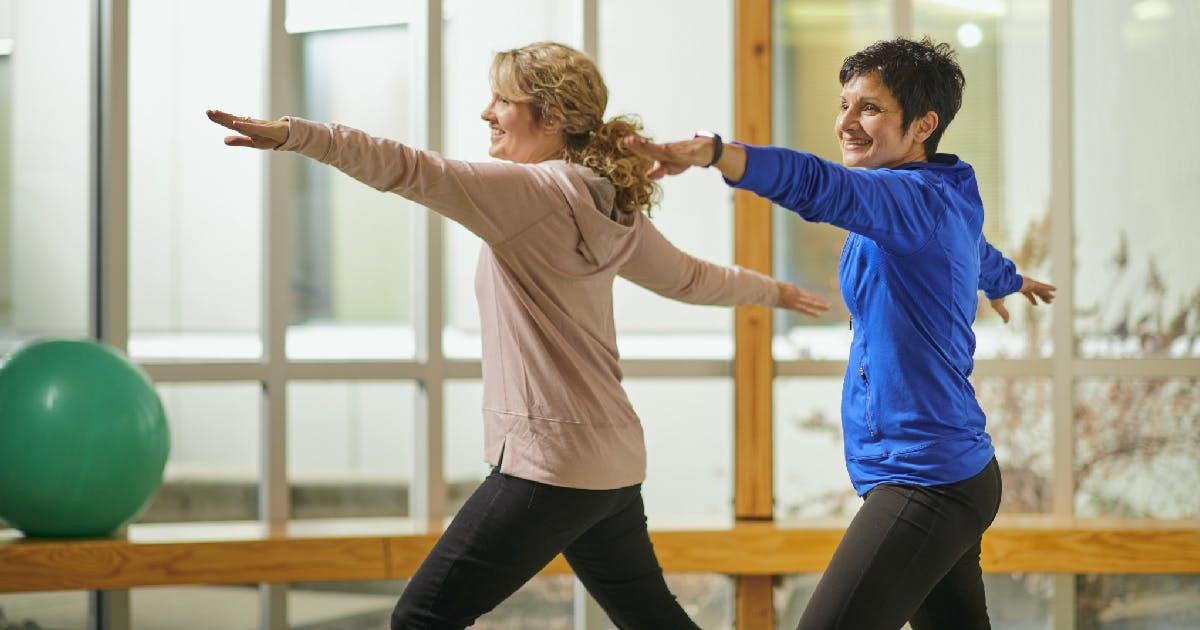 Two women exercise together.